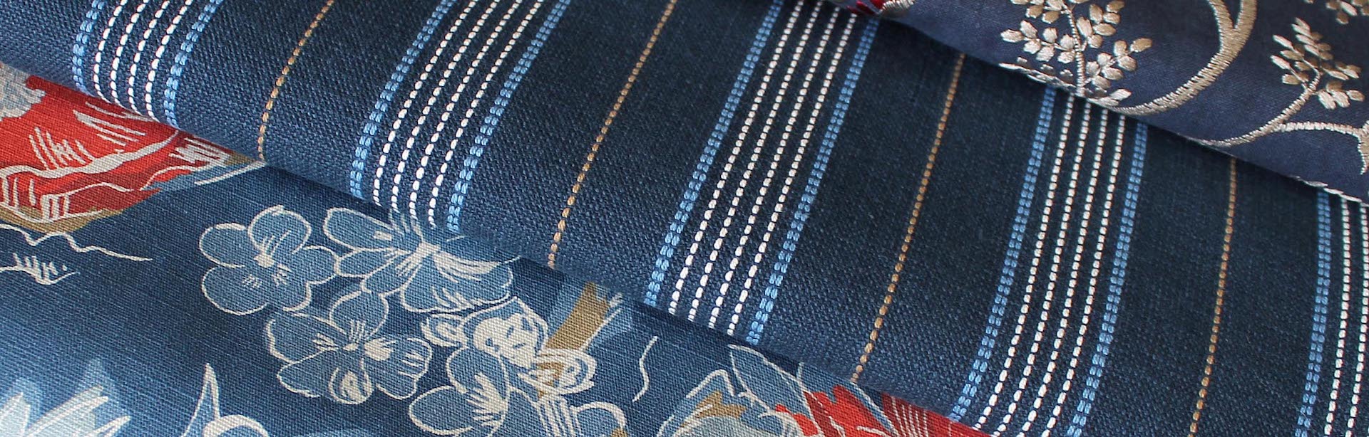 Fabric – Blue and Red 2020_2 Detail of three dark blue fabrics with different prints in white, beige, light blue and red from Carole Fabrics.