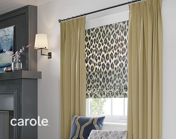 Animal print flat roman shades complemented by golden pleated draperies.