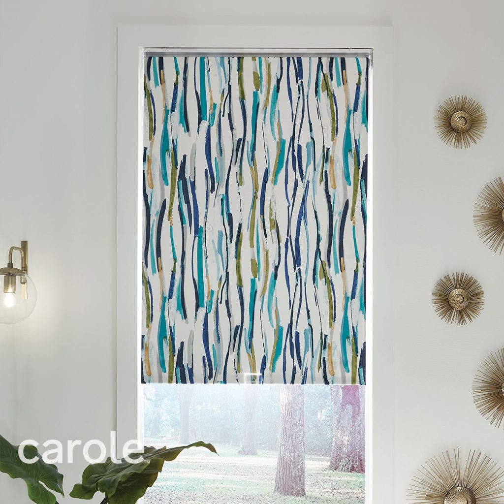 Straight-on view of a Reverse Roll Inside Mount Decorative Fabric Roller Shade with an abstract print in a white room.