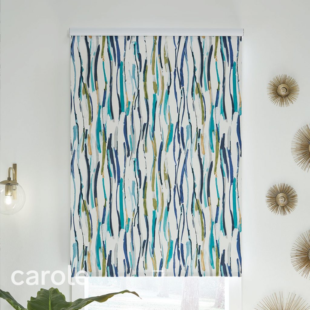 Straight-on view of a Standard Roll Outside Mount Decorative Fabric Roller Shade with an abstract print in a white room.