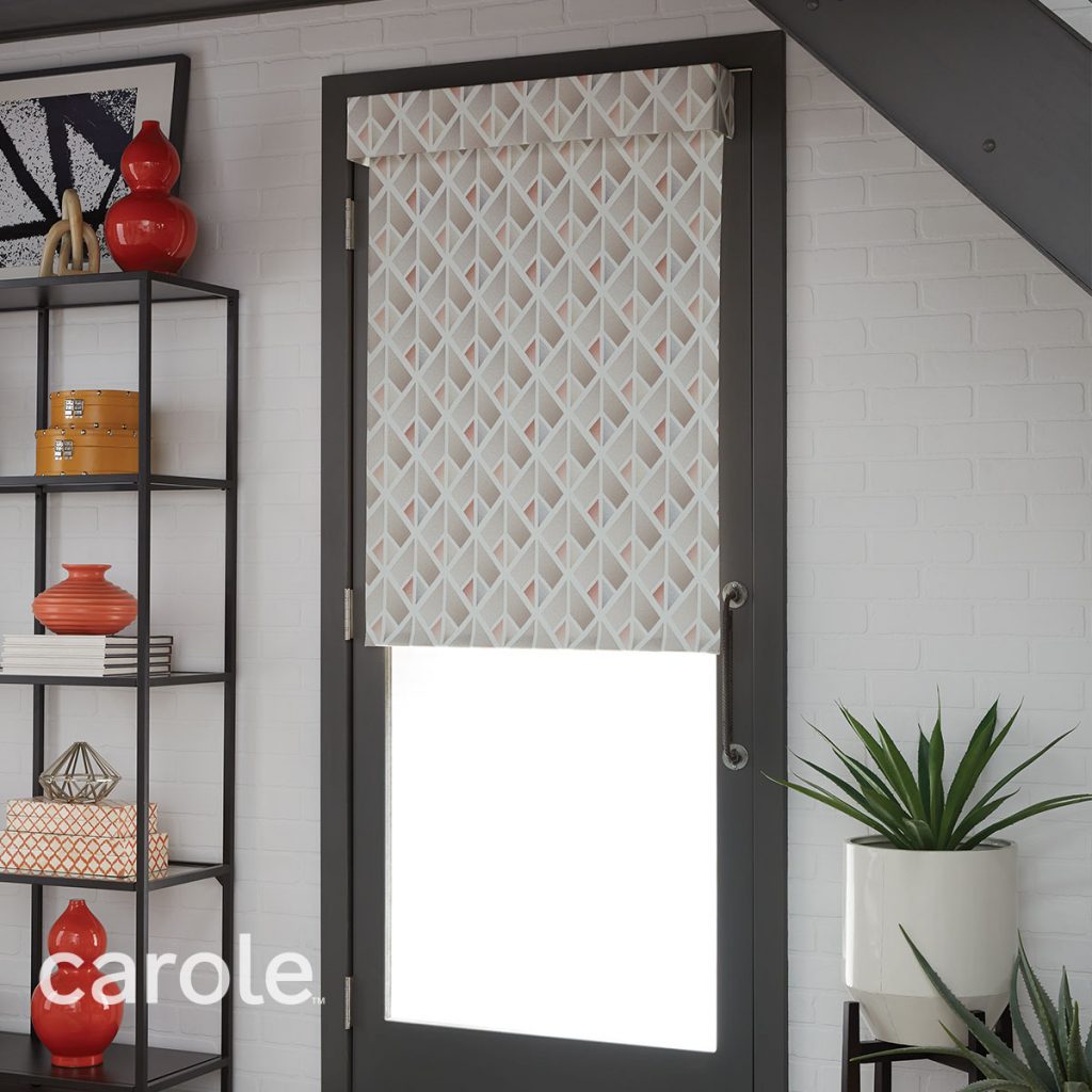 A glass door with a Standard Roll Outside Mount Decorative Fabric Roller Shades and Attached Valance in a neutral geometric pattern.