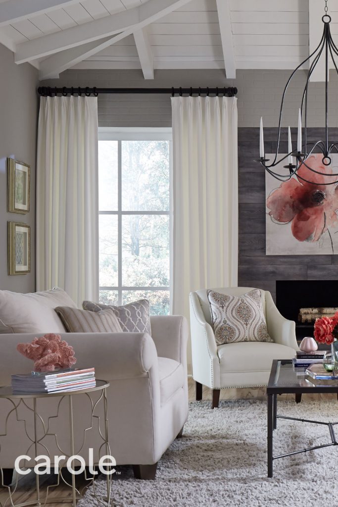 White Inverted Pleat Drapery in a soft neutral living room with dark pink accents.