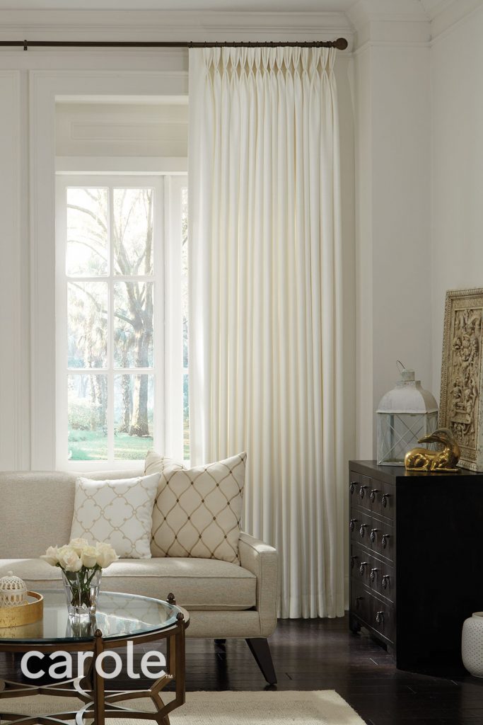 Ivory Three Finger Pinch Pleat Drapery in a warm neutral living room.