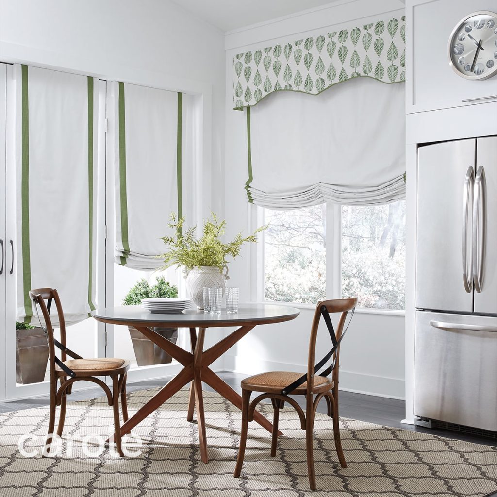 Small dining area with Atlanta Cornice top treatment and Soft Roman Shades in white with leaf green accents.
