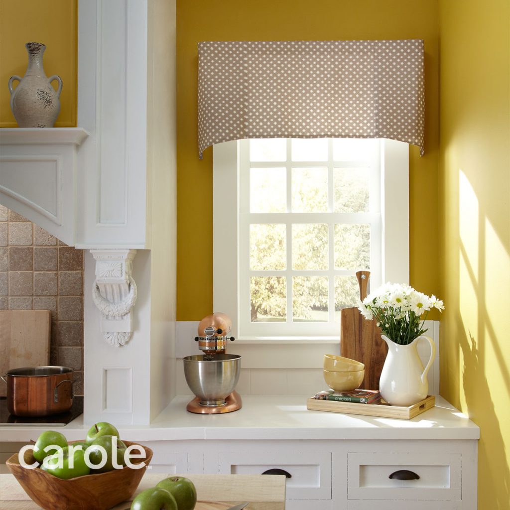 Polka dotted Briscoe Rod Mounted Valance top treatment in a bright yellow and white kitchen.