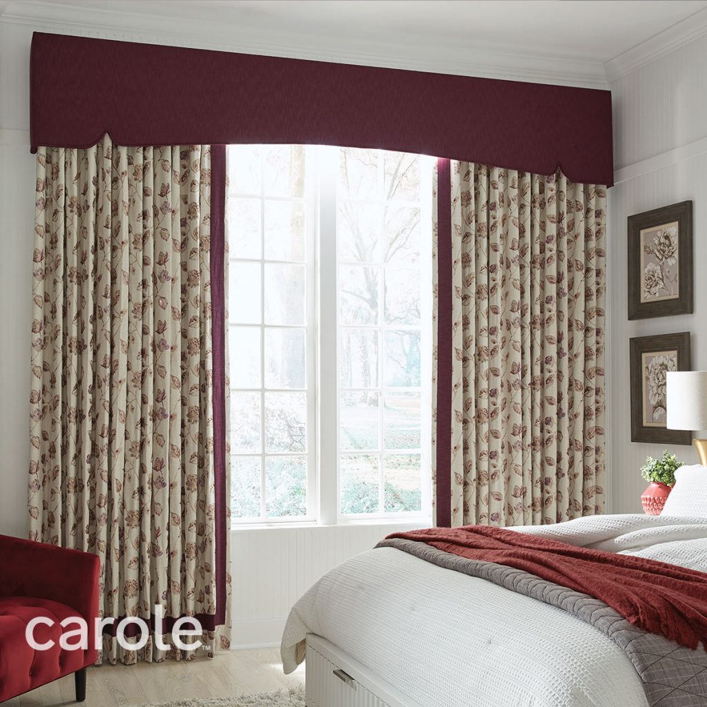 Deep red Savannah Cornice top treatment over red and cream leaf-patterned drapery in a bedroom.