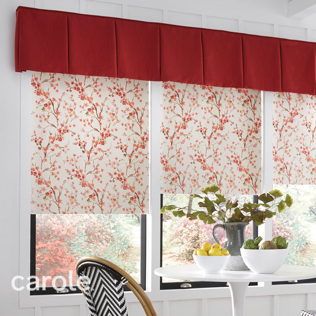 Red Sheldon Board Mounted Valance top treatment over Decorative Fabric Roller Shades with a red and ivory floral pattern in a white dining area.