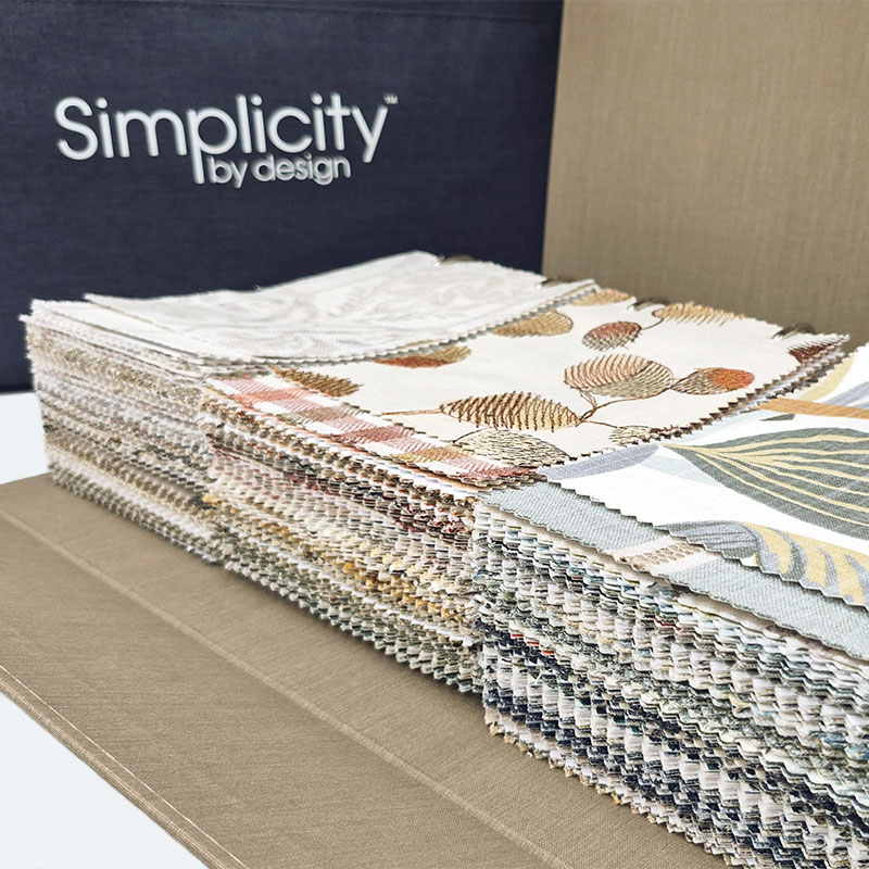 Simplicity By Design 7 fabrics in open binder next to bag.