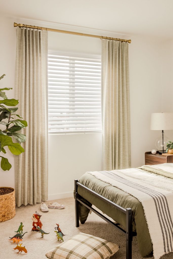 A light and airy bedroom featuring a large sunlit window with Single Pleat EZ Panels.
