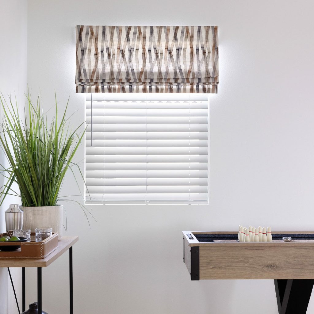 A modern striped embroidery pattern on a Falt Faux Roman in a game room.