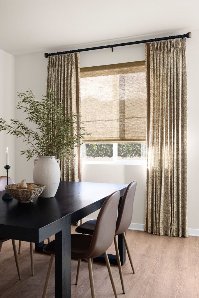 A relaxed dining room featuring a window with Three Finger Pinch Pleat Drapery.
