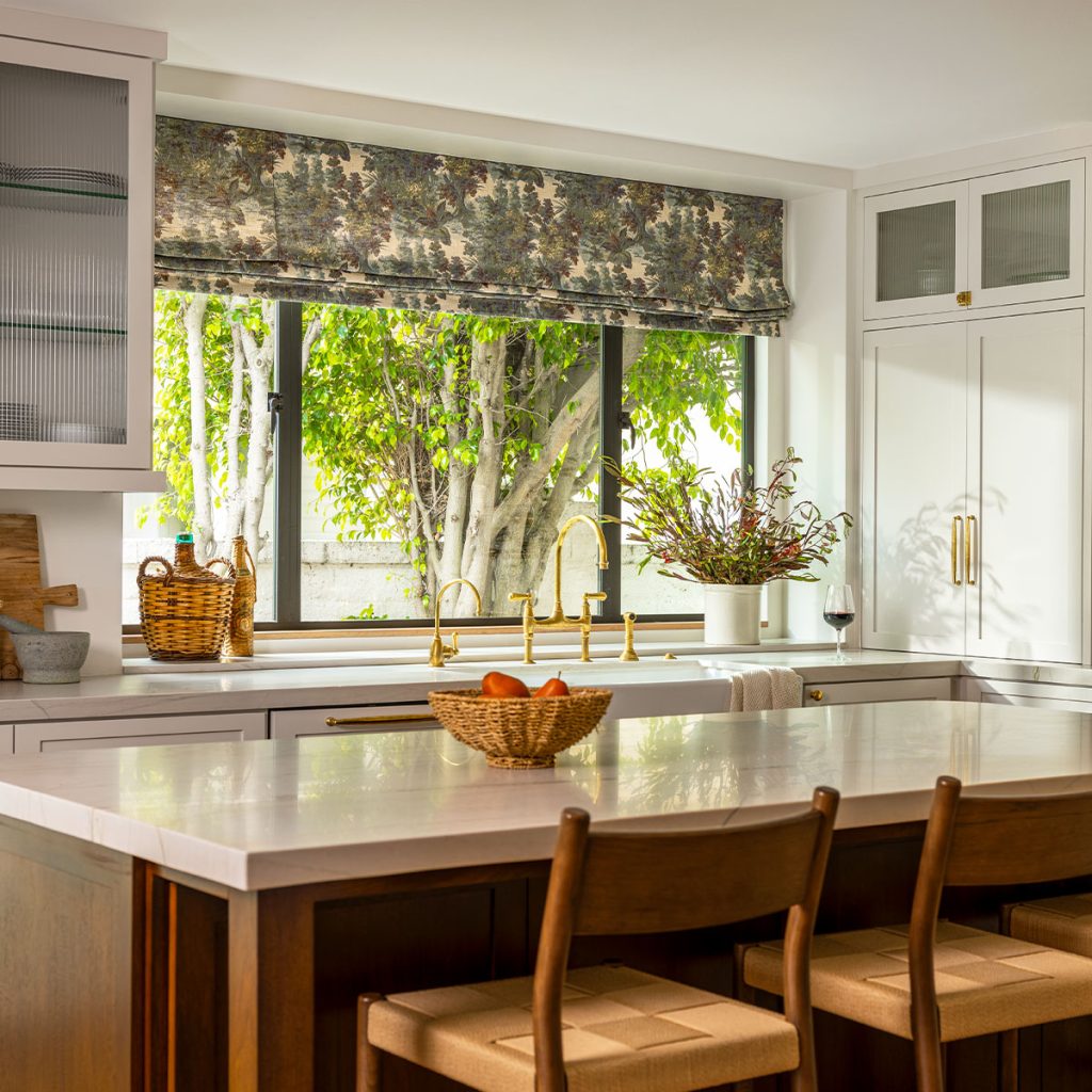 A kitchen featuring a large window over the sink with a Flat Faux Roman in a green and brown foliage pattern.